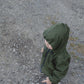 A young child in a Waterproof Baby/Kid Clothing Set - Khaki from MellowConceptStore stands on a gravel path, looking to the side.