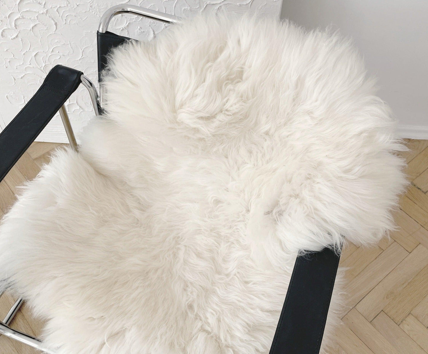 A chair with a white Natural Sheepskin Rug for Pet from Mellow Pet Store, suitable for Organic pet accessories.