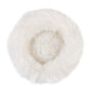 A Round Natural Sheepskin Pet Bed made from natural sheepskin on a white background by Mellow Pet Store.