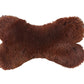 A brown furry Natural Sheepskin Dog Toy Bone made with natural materials by Mellow Pet Store.